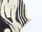Monochrome Muse – Abstract Tie-Neck Blouse