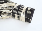 Monochrome Muse – Abstract Tie-Neck Blouse